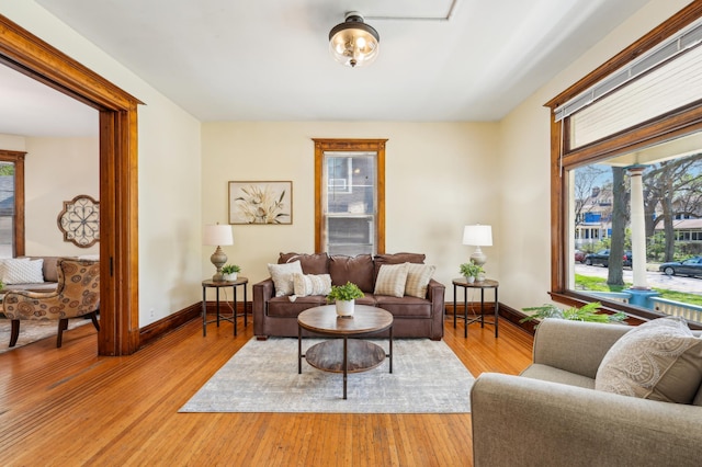 living room with light wood-style flooring and baseboards