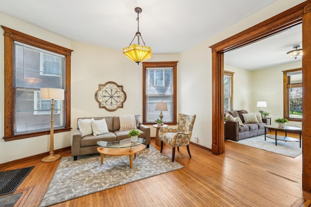 sitting room featuring baseboards and hardwood / wood-style floors