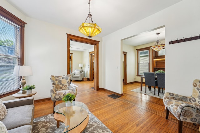 living room with light wood-type flooring and baseboards