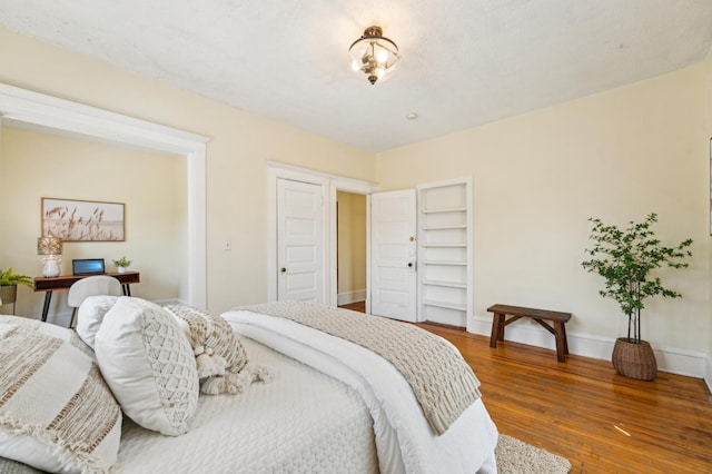 bedroom featuring wood finished floors and baseboards