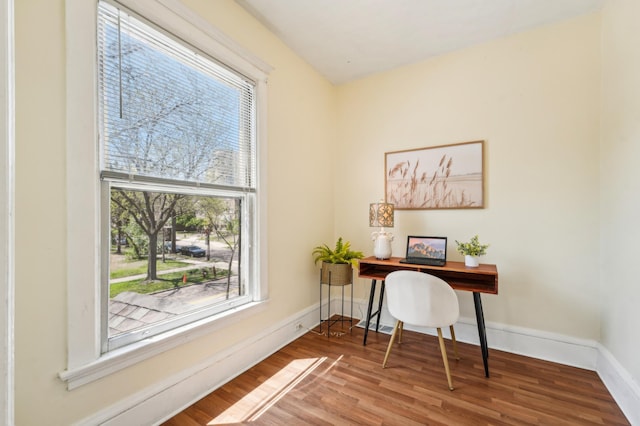 home office featuring wood finished floors and baseboards