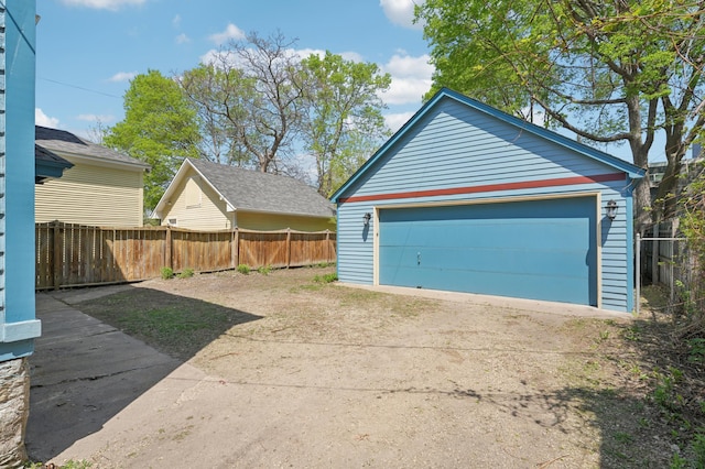 detached garage featuring fence