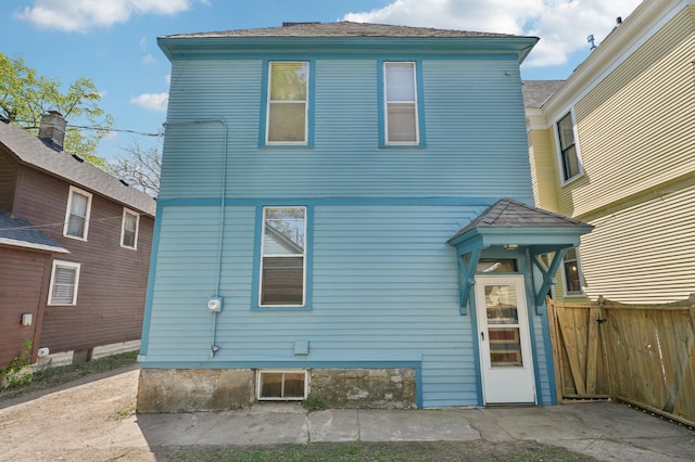 rear view of house with fence