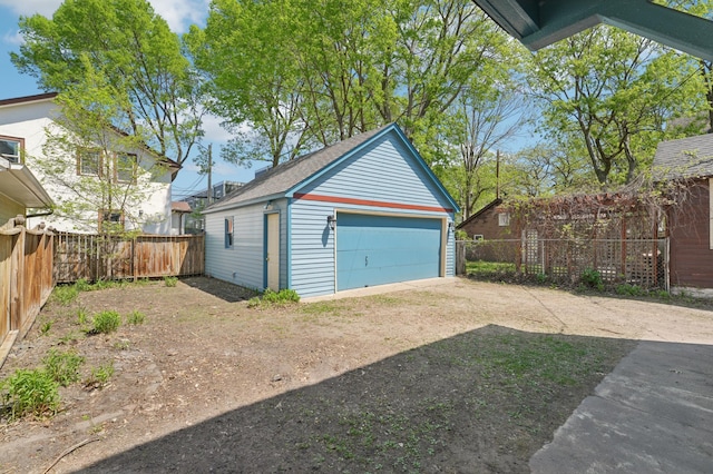 detached garage featuring fence