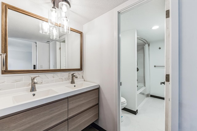 6417 Colony Way Unit 2A, Edina, MN 55435 - bathroom with a sink, a textured ceiling, double vanity, and toilet