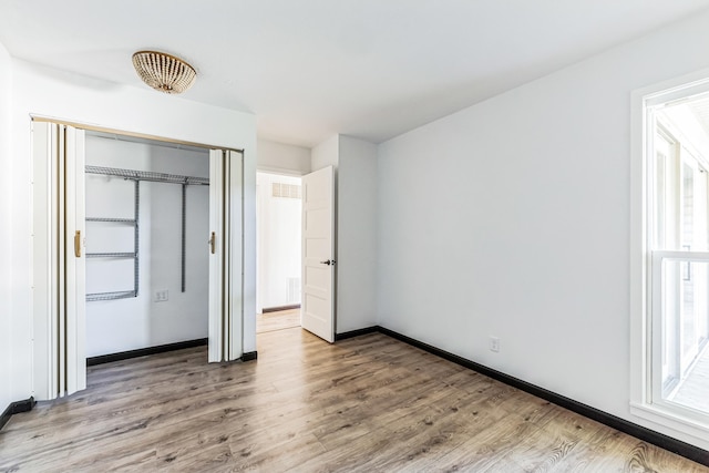 6417 Colony Way Unit 2A, Edina, MN 55435 - unfurnished bedroom with a closet, light wood-type flooring, and baseboards