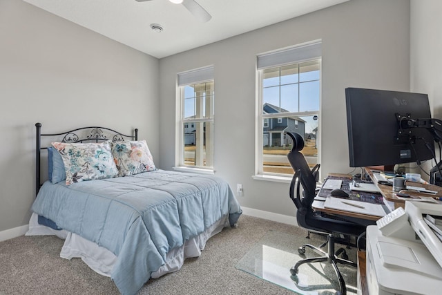 bedroom with a ceiling fan, carpet, and baseboards