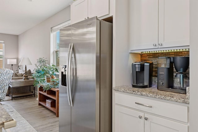 kitchen with a healthy amount of sunlight, white cabinetry, and stainless steel fridge with ice dispenser