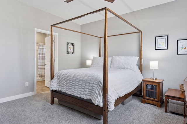 carpeted bedroom featuring baseboards and ensuite bathroom