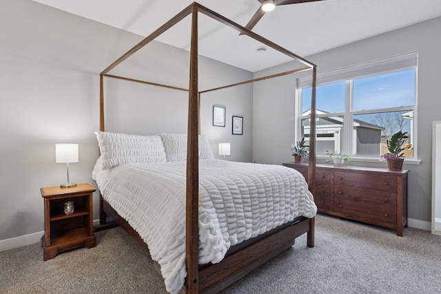 bedroom with light colored carpet and baseboards