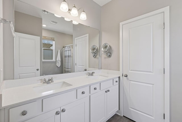 bathroom with double vanity, visible vents, a shower with shower curtain, and a sink