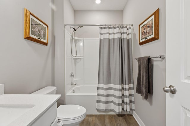 bathroom featuring vanity, toilet, wood finished floors, and shower / bath combo