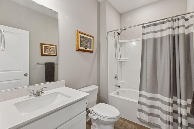 bathroom with shower / tub combo, toilet, wood finished floors, and vanity