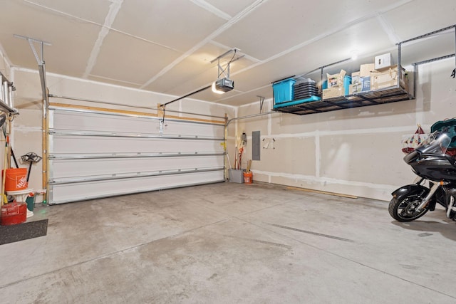 garage with electric panel and a garage door opener