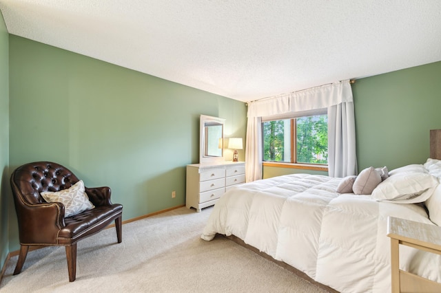 bedroom with light carpet, a textured ceiling, and baseboards