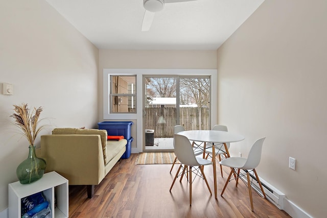 dining space featuring baseboards, ceiling fan, and wood finished floors