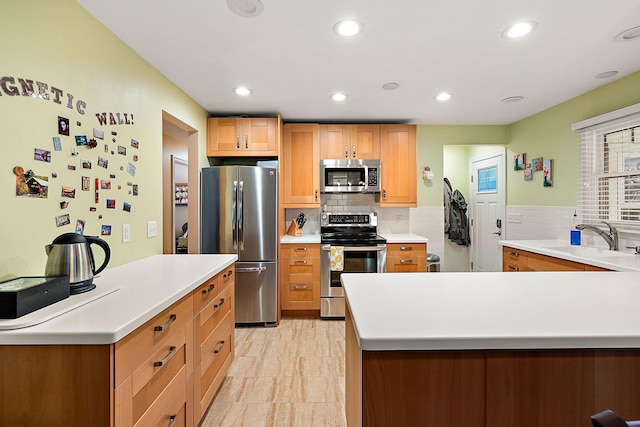 kitchen with recessed lighting, tasteful backsplash, appliances with stainless steel finishes, and a sink