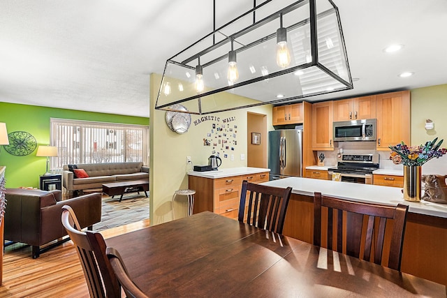 dining area featuring recessed lighting and light wood finished floors