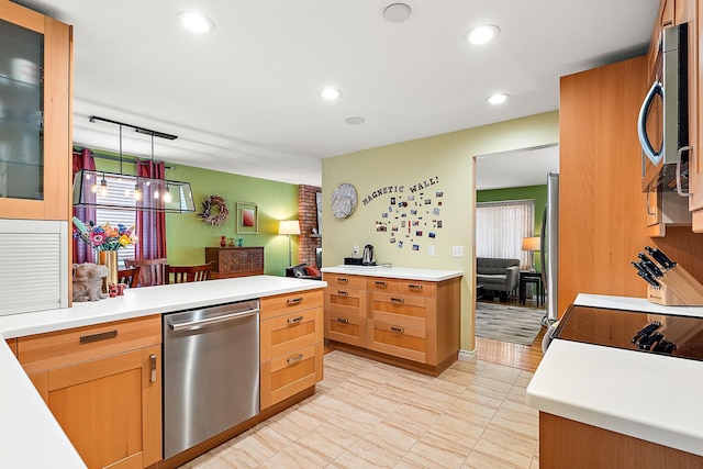 kitchen with glass insert cabinets, pendant lighting, light countertops, recessed lighting, and appliances with stainless steel finishes