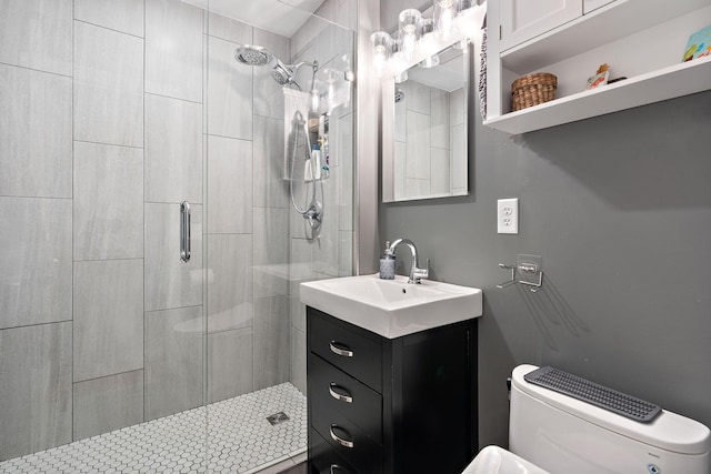 full bathroom featuring vanity, a shower stall, and toilet