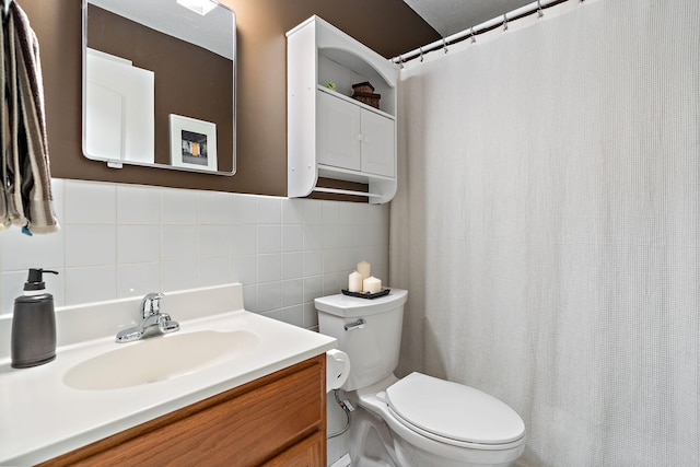 full bathroom with vanity, toilet, tile walls, and a shower with curtain