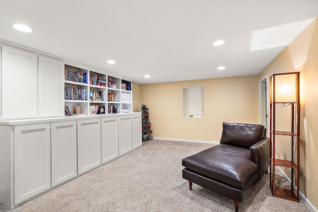 sitting room with recessed lighting, light colored carpet, and baseboards