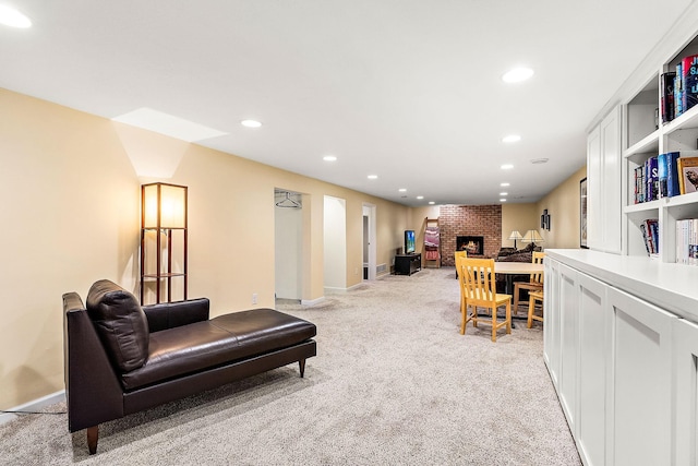 living area with a fireplace, recessed lighting, baseboards, and light carpet