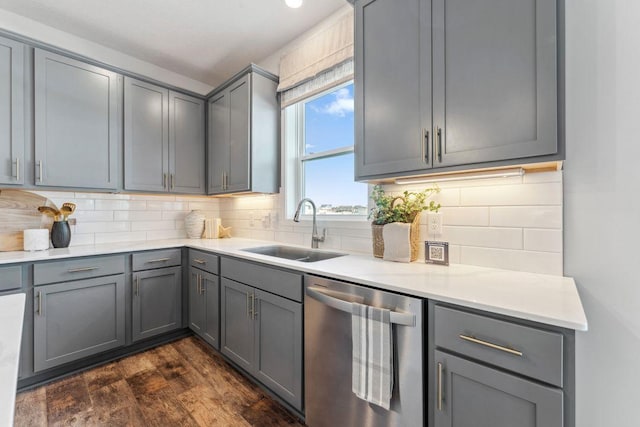 kitchen with a sink, gray cabinetry, and stainless steel dishwasher