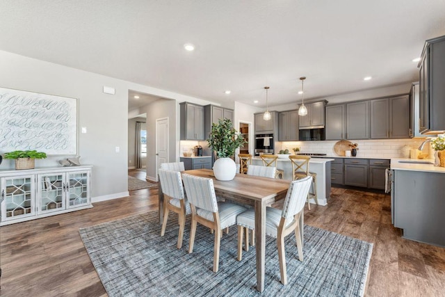 dining area with recessed lighting, baseboards, and dark wood-style flooring