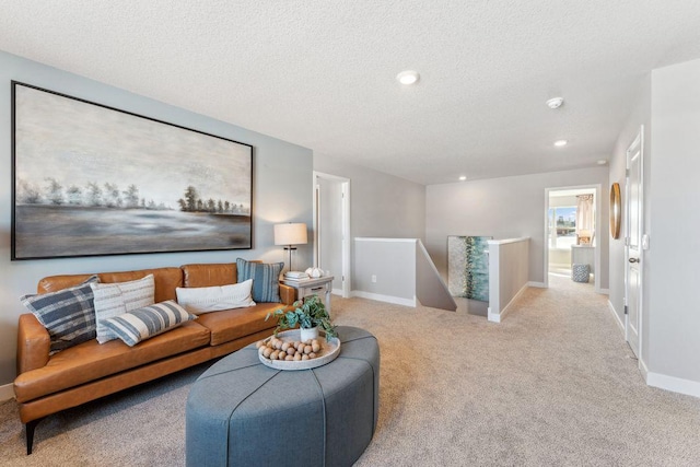 living area with carpet flooring, recessed lighting, baseboards, and a textured ceiling