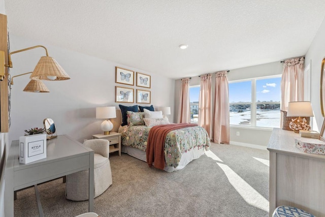 bedroom with baseboards, carpet floors, and a textured ceiling