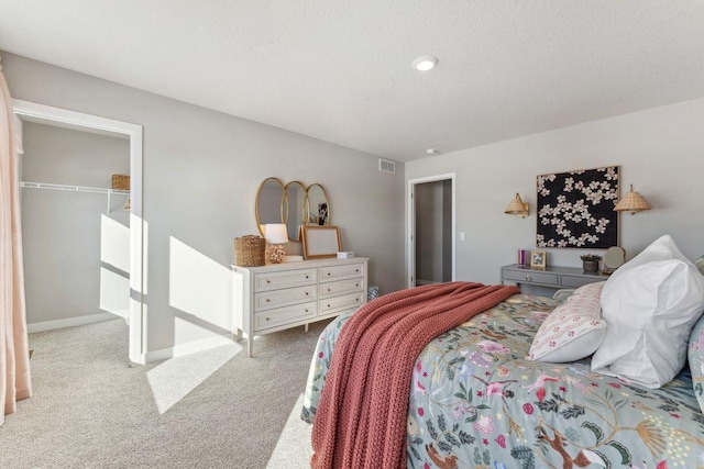 bedroom with visible vents, baseboards, and carpet