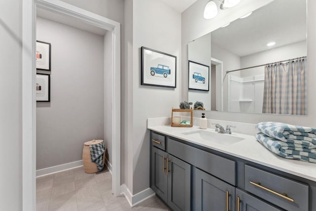 full bath with curtained shower, baseboards, and vanity