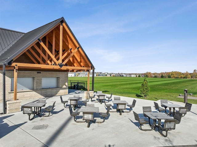 surrounding community with a patio and a lawn