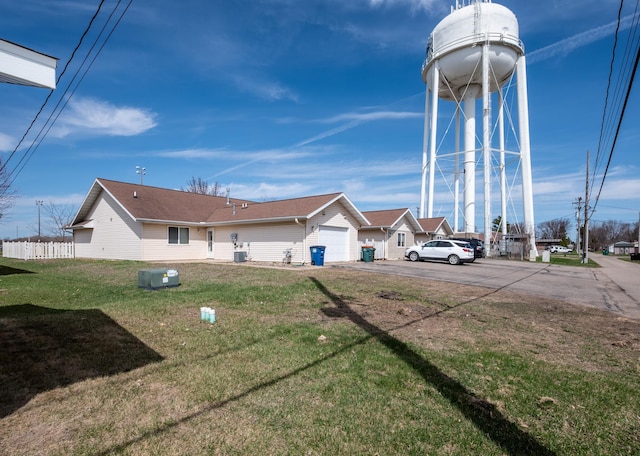 510,512,514 4th Street Ne, Staples, MN 56479 - exterior space featuring cooling unit, driveway, a garage, and fence