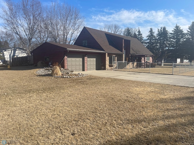 view of front of house with a garage, a front yard, driveway, and fence