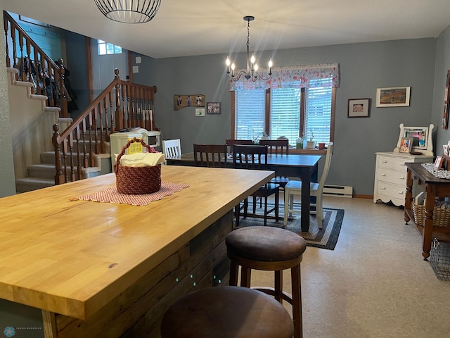 dining area featuring a notable chandelier, stairway, baseboard heating, and baseboards