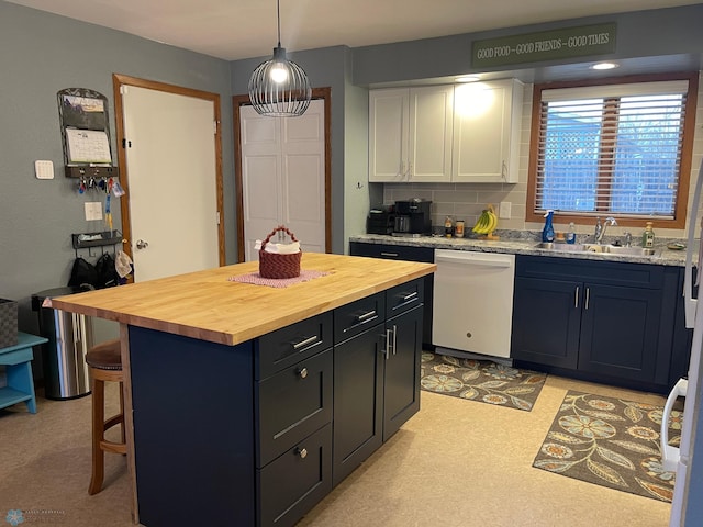 kitchen featuring a sink, wood counters, a kitchen breakfast bar, white cabinets, and dishwasher