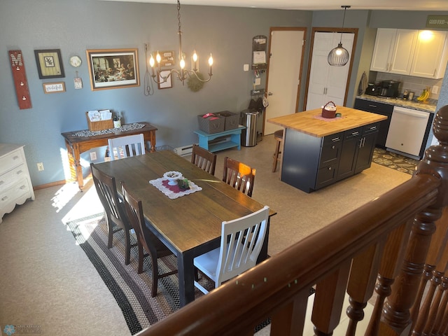 dining area featuring baseboard heating, baseboards, and an inviting chandelier