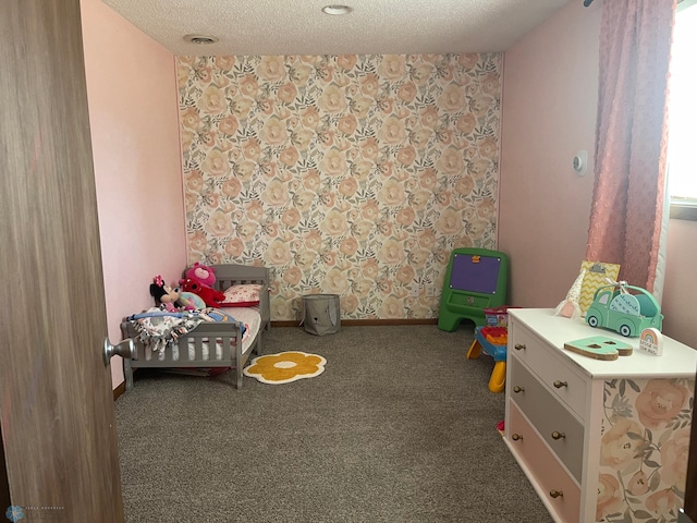 carpeted bedroom with baseboards and a textured ceiling