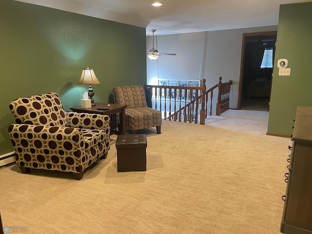 living area featuring a ceiling fan, recessed lighting, a textured ceiling, carpet flooring, and an upstairs landing