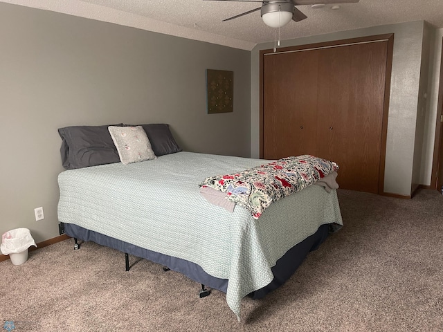 bedroom featuring a textured ceiling, a closet, carpet floors, baseboards, and ceiling fan