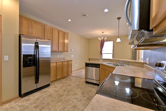 kitchen with a sink, decorative light fixtures, stainless steel appliances, an inviting chandelier, and light countertops