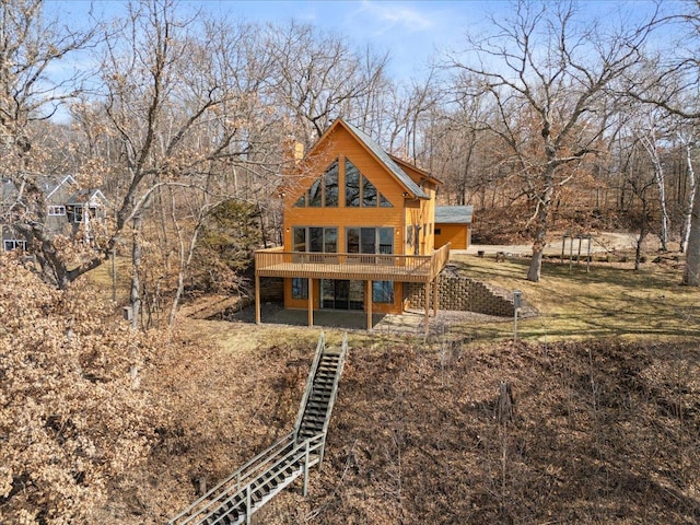 rear view of house featuring a deck and stairway