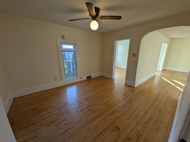 2309 Buchanan St NE, Minneapolis, MN 55418 - unfurnished room with a ceiling fan, visible vents, arched walkways, and light wood finished floors