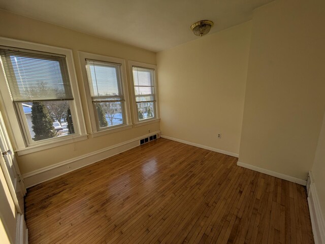 2309 Buchanan St NE, Minneapolis, MN 55418 - unfurnished room with baseboards, visible vents, and wood-type flooring