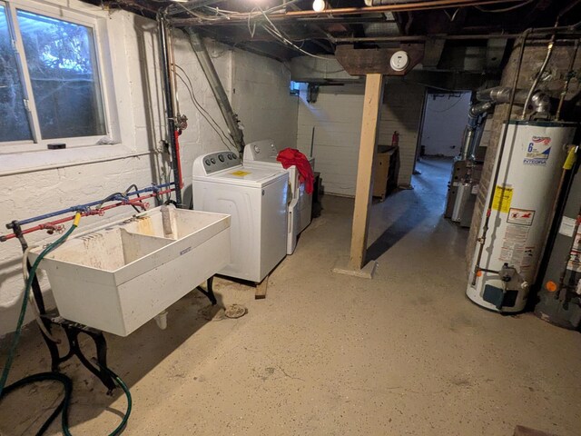 2309 Buchanan St NE, Minneapolis, MN 55418 - unfinished basement featuring gas water heater, washer and clothes dryer, and a sink