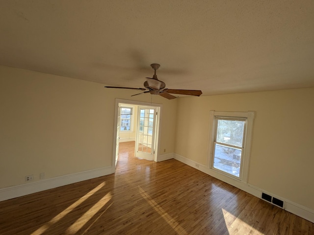2309 Buchanan St NE, Minneapolis, MN 55418 - unfurnished room with a wealth of natural light, visible vents, baseboards, and wood finished floors