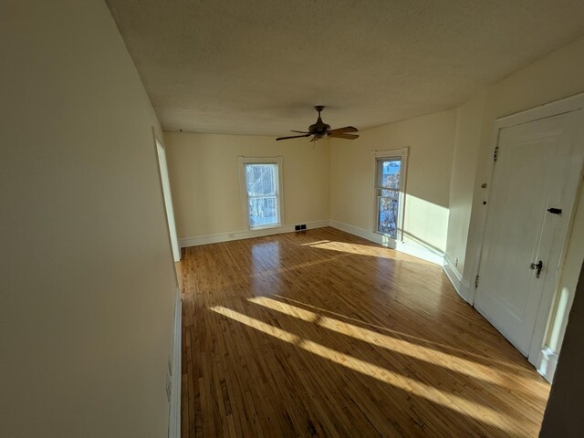 2309 Buchanan St NE, Minneapolis, MN 55418 - unfurnished room featuring visible vents, ceiling fan, baseboards, a textured ceiling, and wood-type flooring