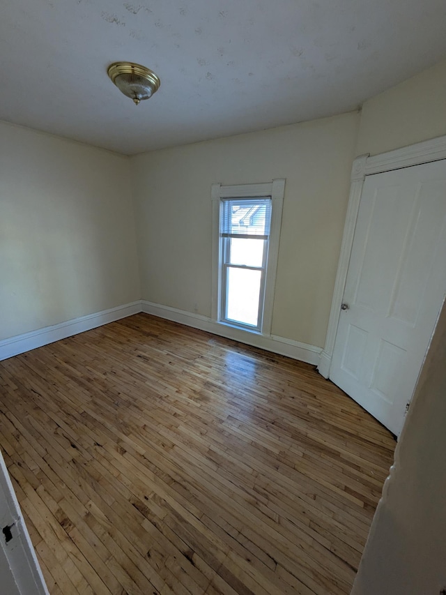 2309 Buchanan St NE, Minneapolis, MN 55418 - empty room featuring baseboards and hardwood / wood-style floors
